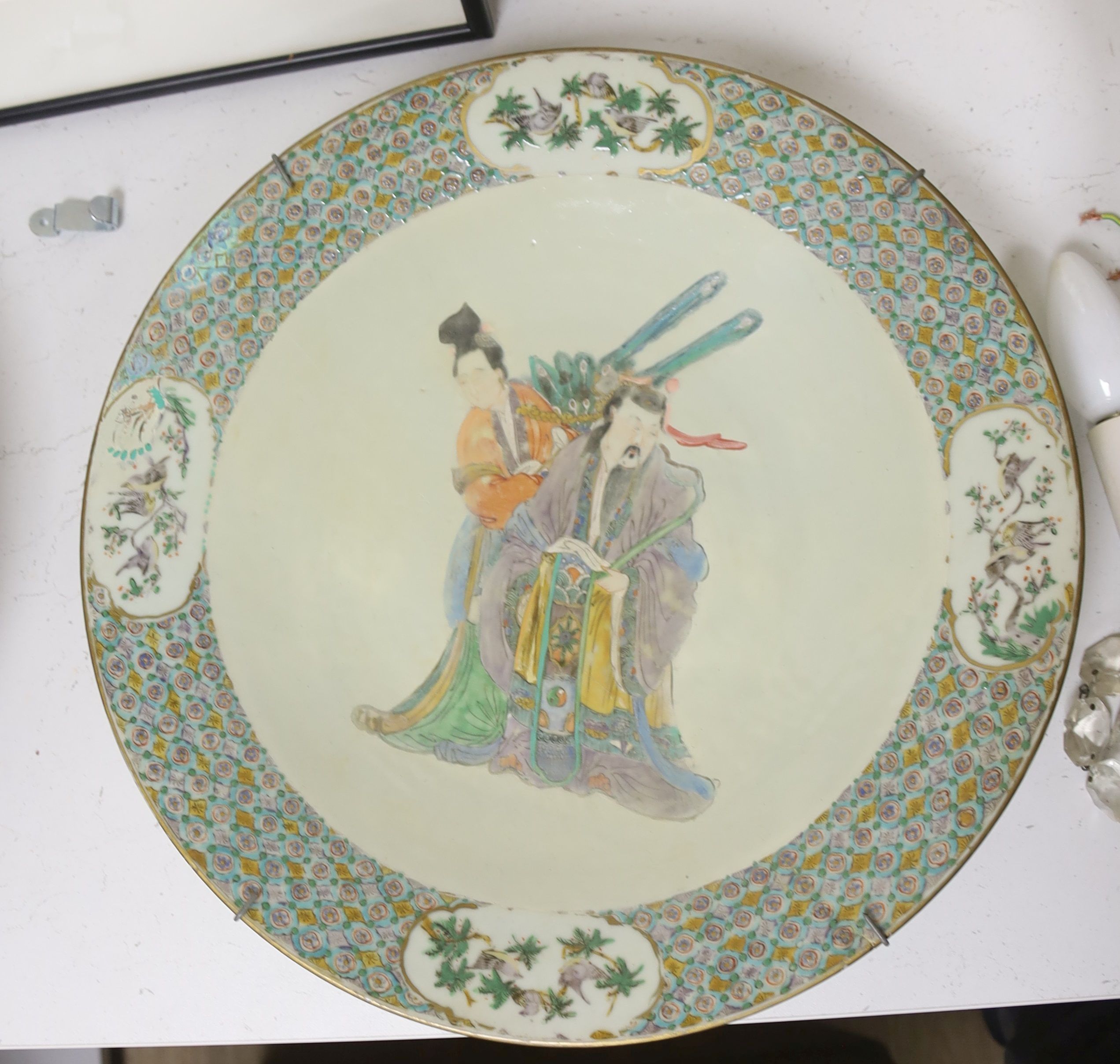 A Chinese enamelled porcelain 'immortals' dish, 19th century, diameter 38cm, restored